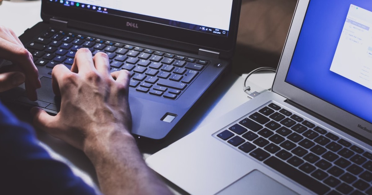 A person with two laptops on their desk (Source: Unsplash/freestocks)