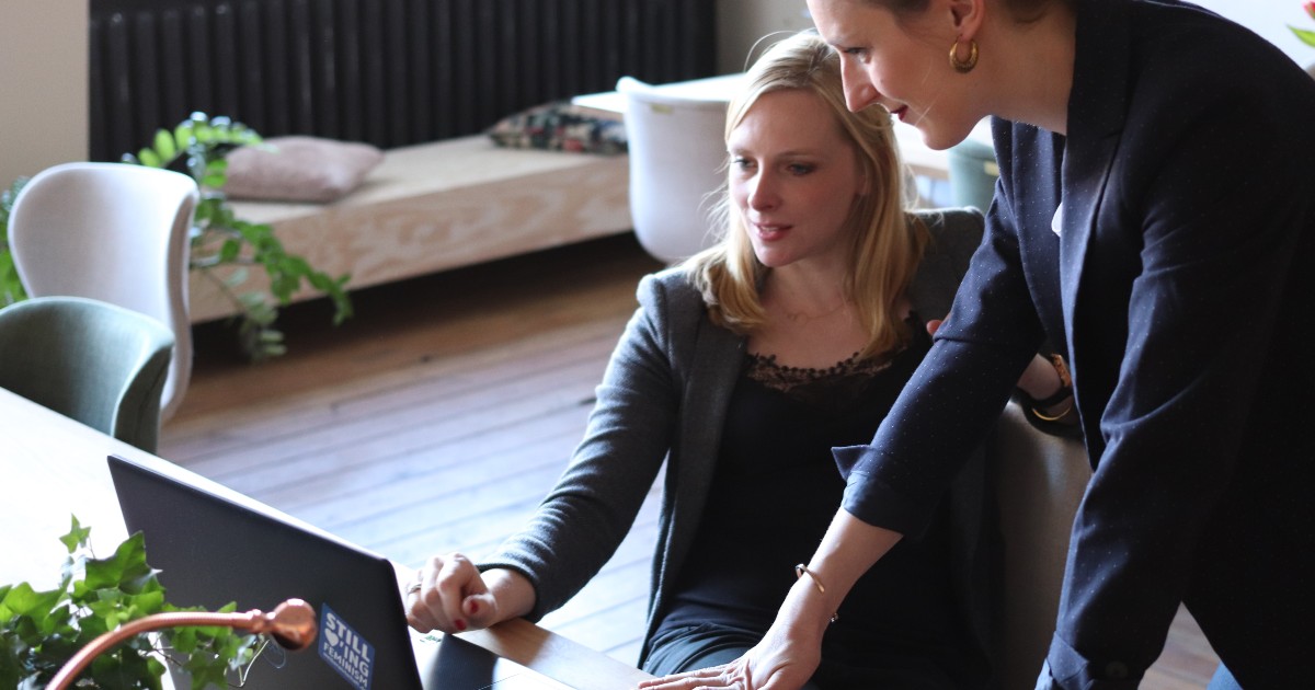 Image of two women looking at a laptop