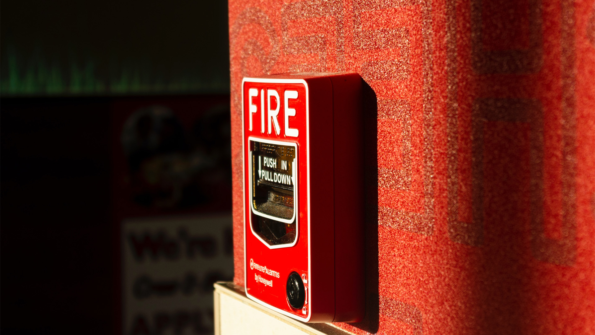 decorative: a red fire alarm mounted onto a wall