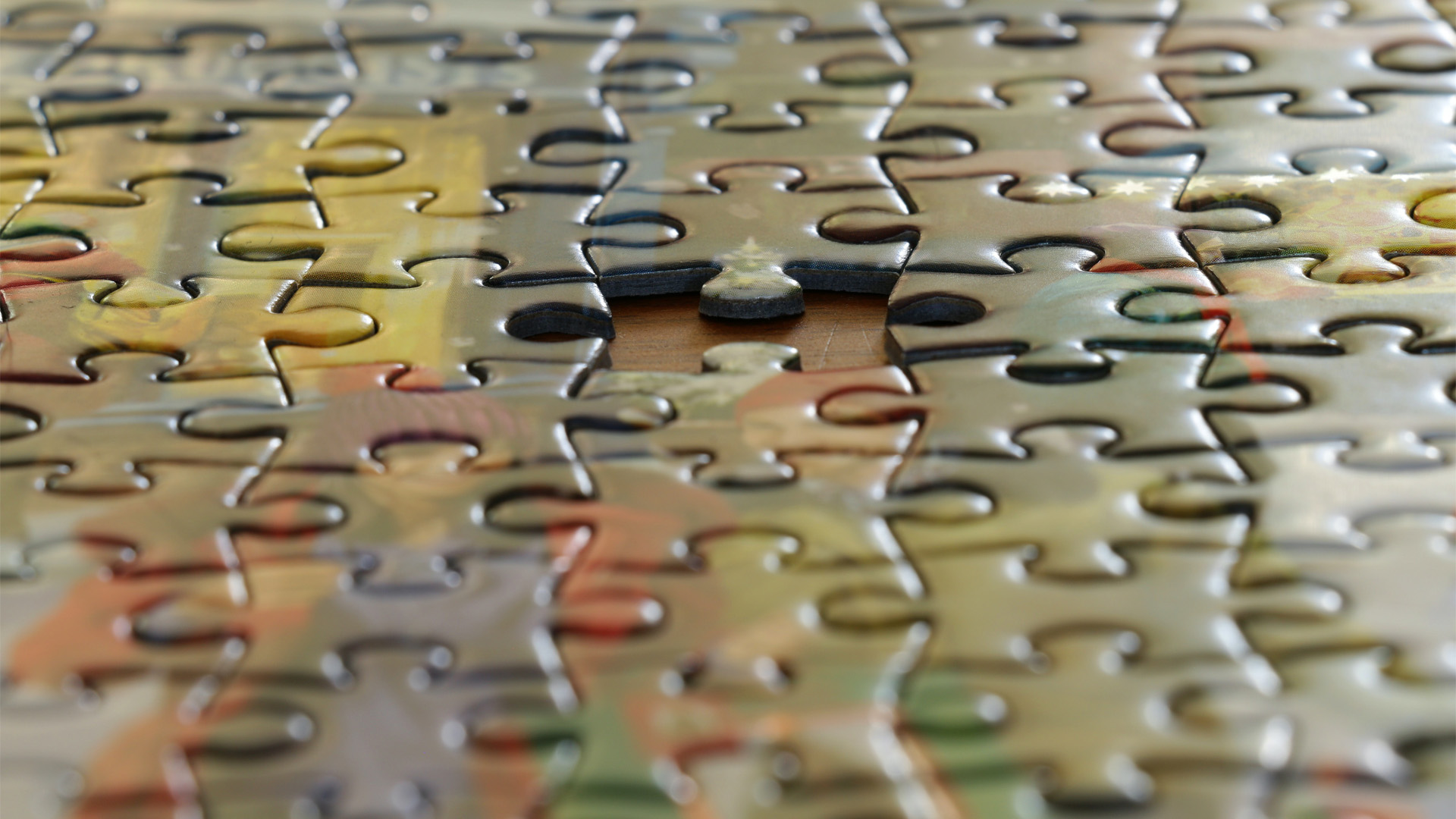 A macro photograph of a puzzle showing the missing piece